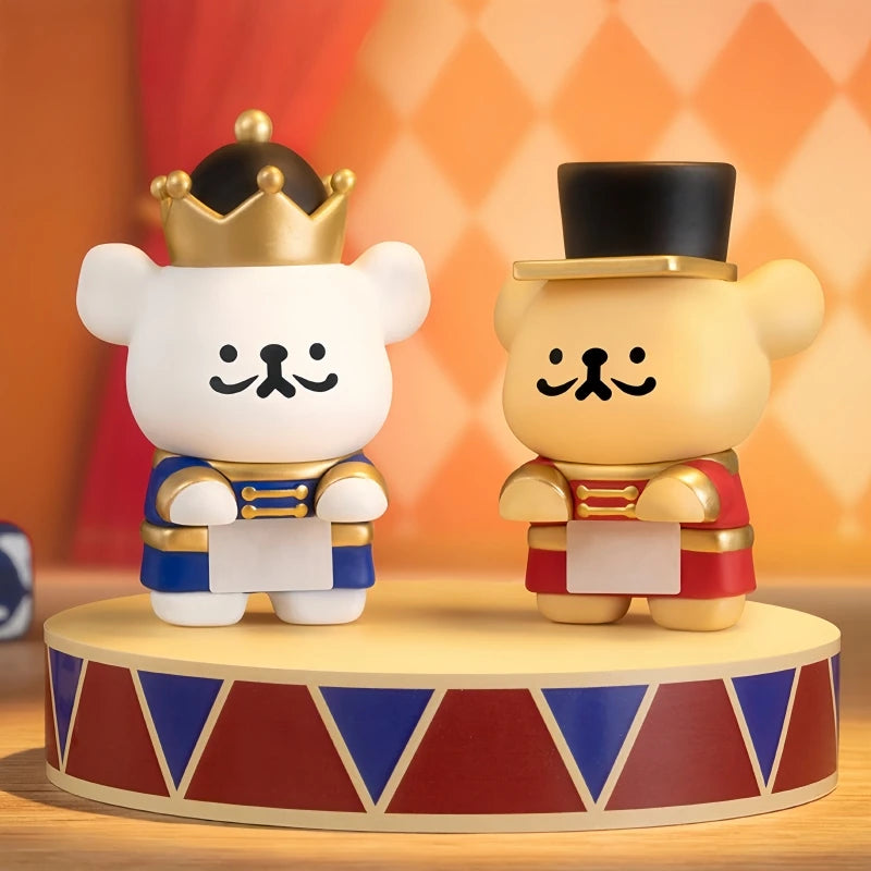 Two bear figurines with crowns and hats on a decorative stand with a colorful background