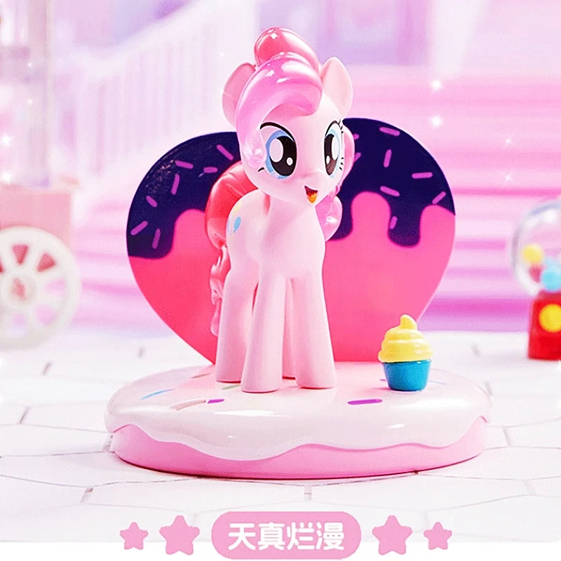 Pink pony figurine on a heart-shaped platform with a donut background