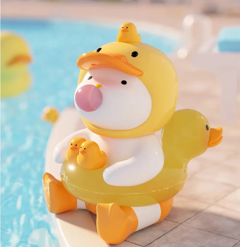 Inflatable duck toy with a smaller duck on its back by a pool