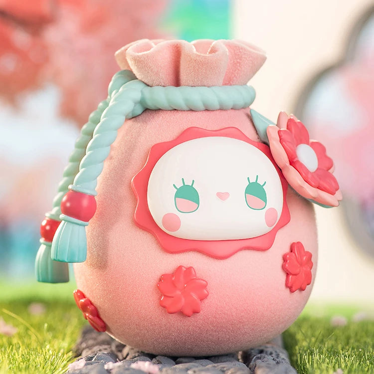 Cute plush toy with a floral design on a grassy background