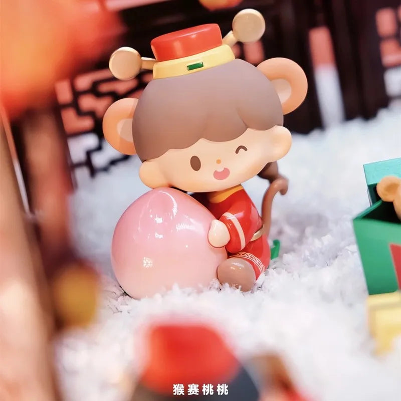 Toy figure of a monkey character holding a pink ball with a blurred background
