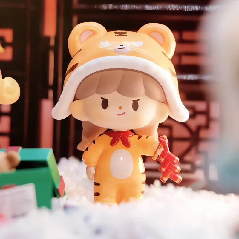 Toy figure of a character with a tiger hat and outfit, holding a red object, on a soft white surface.