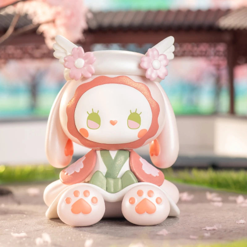 Cute figurine with floral accessories on a blurred outdoor background
