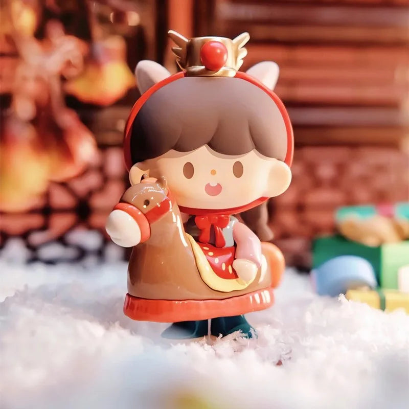 Toy figure of a character with a red hood and brown outfit in a snowy setting