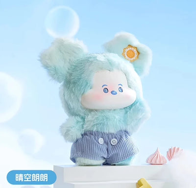 Plush toy with a light blue outfit and white hat on a light blue background