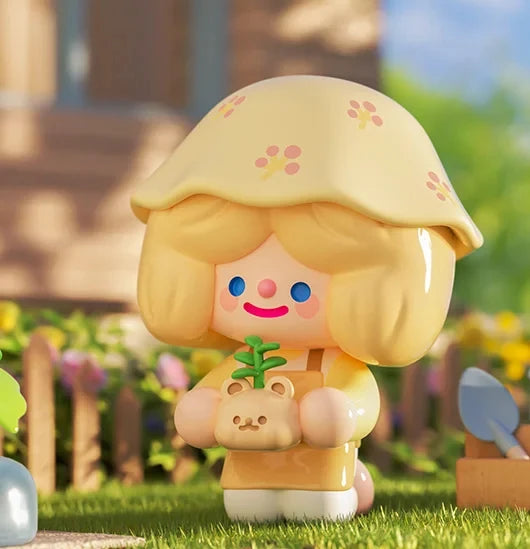 Toy figure with a yellow hat and bear plushie in a garden setting