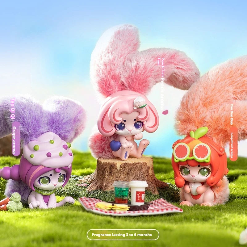 Three colorful character figurines with fluffy hair on a grassy background