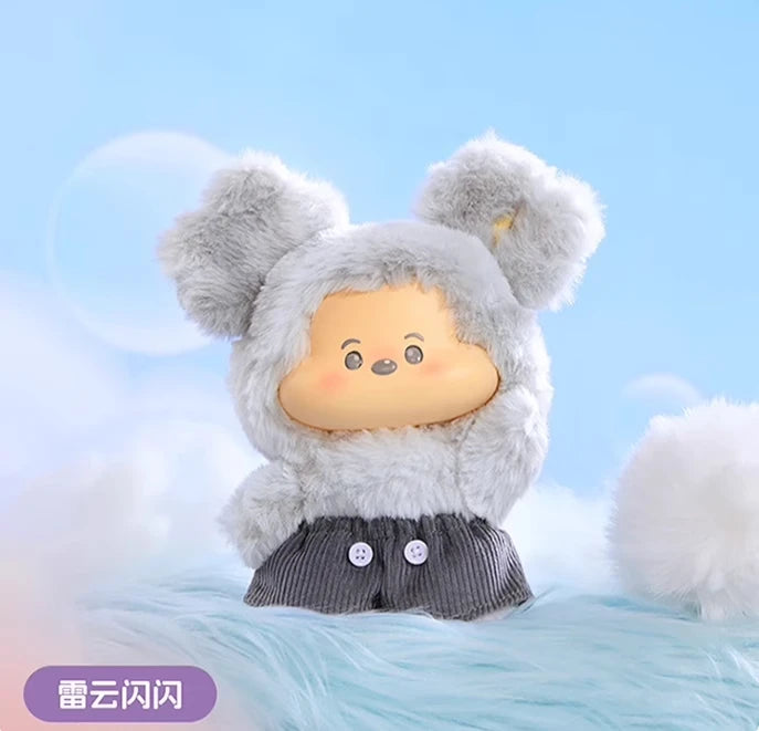 Plush toy with a gray outfit and white ears on a light blue background
