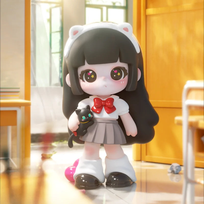 Plush toy with black hair, white outfit, and cat ears holding a small black cat plush toy in a room.