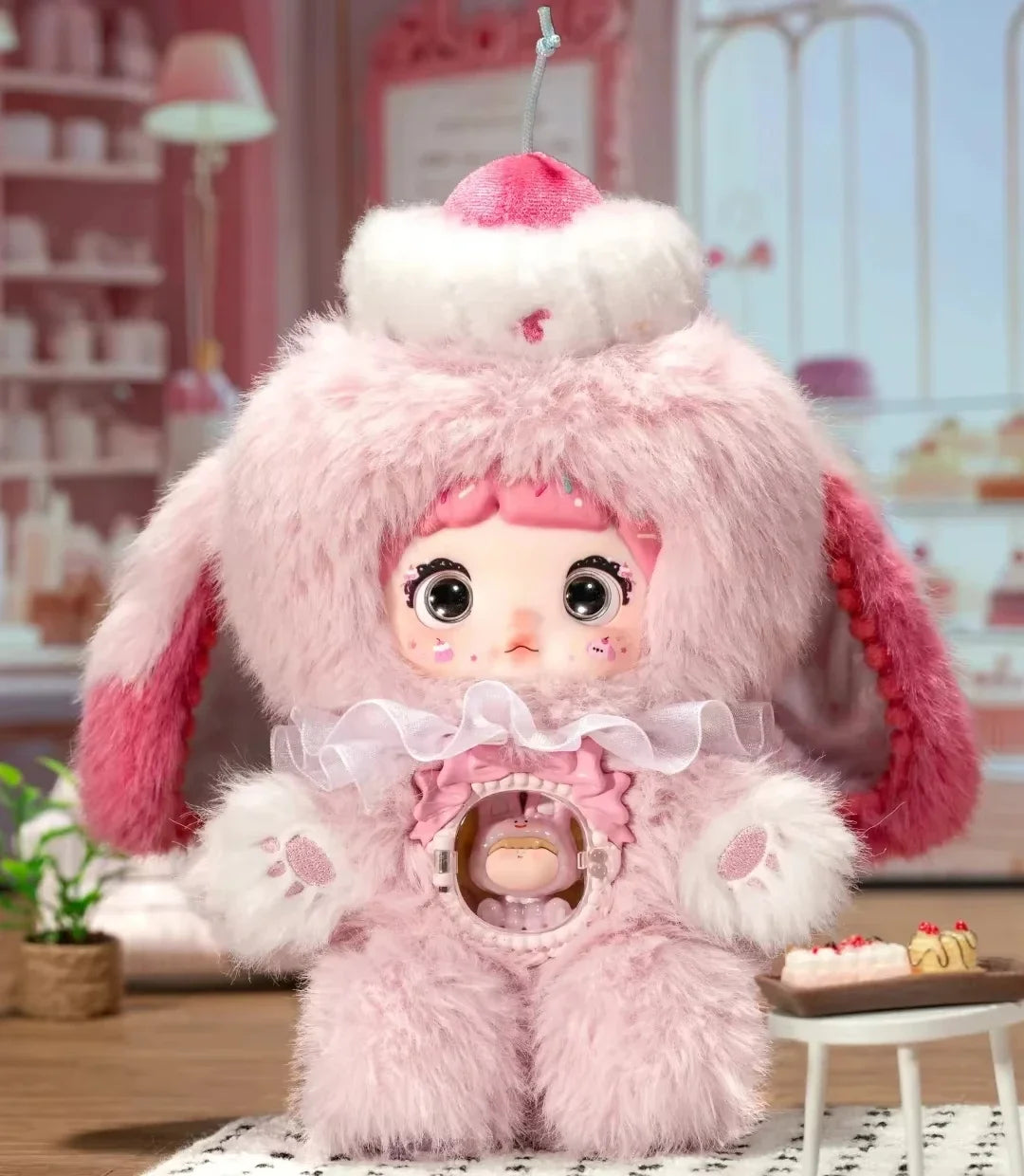Pink plush toy with bunny ears in a room setting