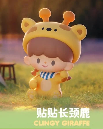 Toy figure of a child in a giraffe costume with 'CLINGY GIRAFFE' text on a blurred outdoor background.