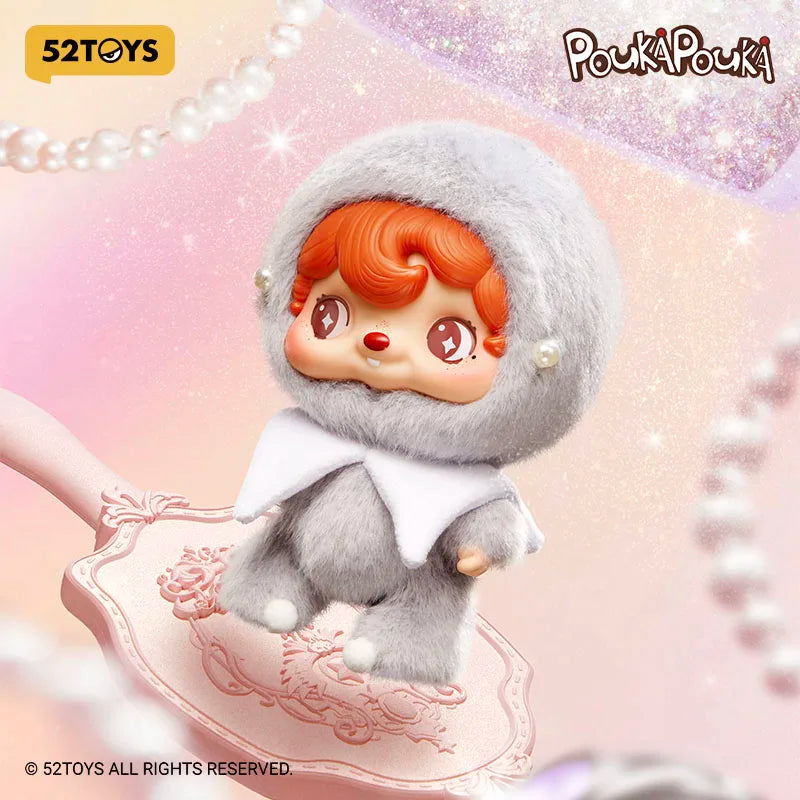 Pouka Pouki figurine with red hair and gray outfit on a decorative background with 52Toys branding.