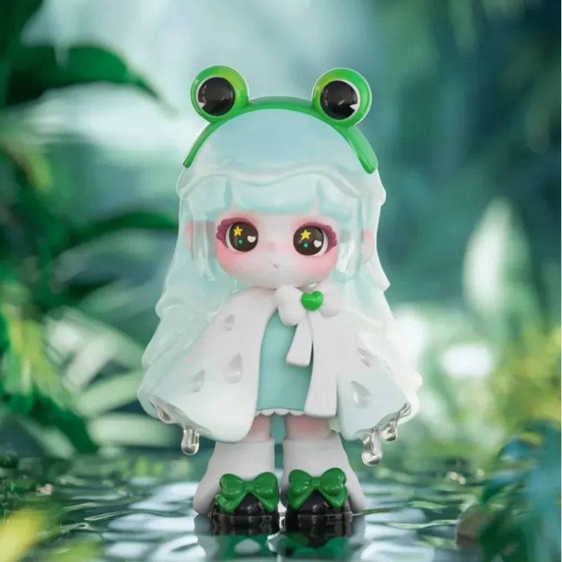Frog-themed figurine with a green headband and white outfit against a blurred green background