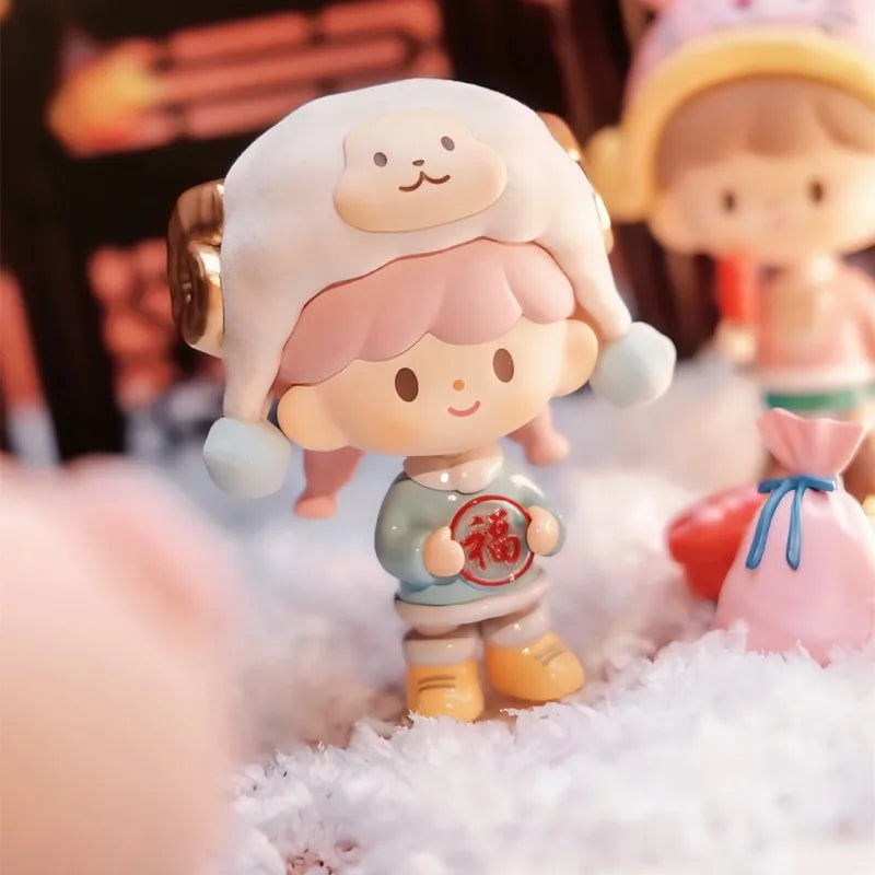 Cute cartoon figurine with pink hair and a white hat on a soft surface.