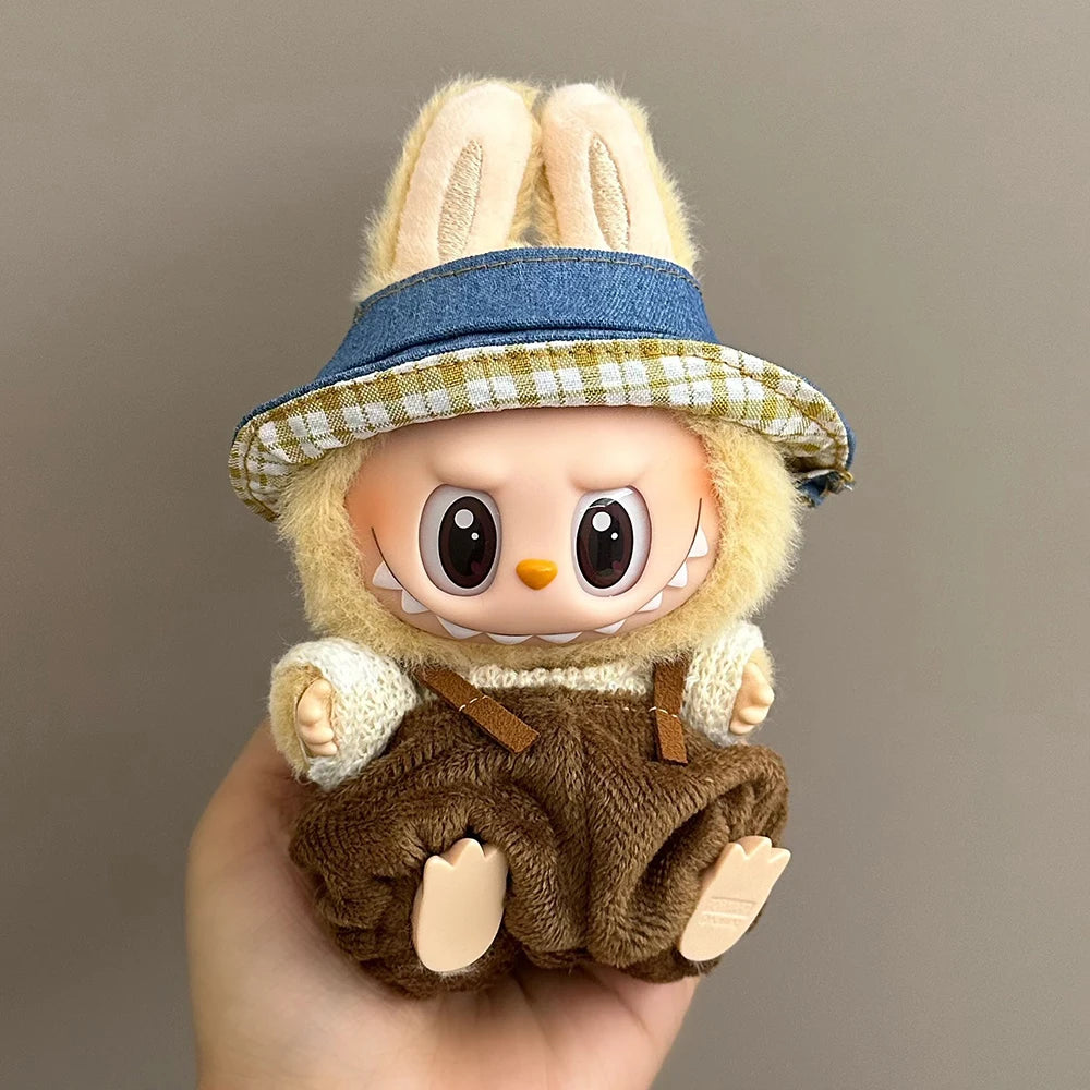 Toy figure of a character with bunny ears and a hat held in a hand against a neutral background