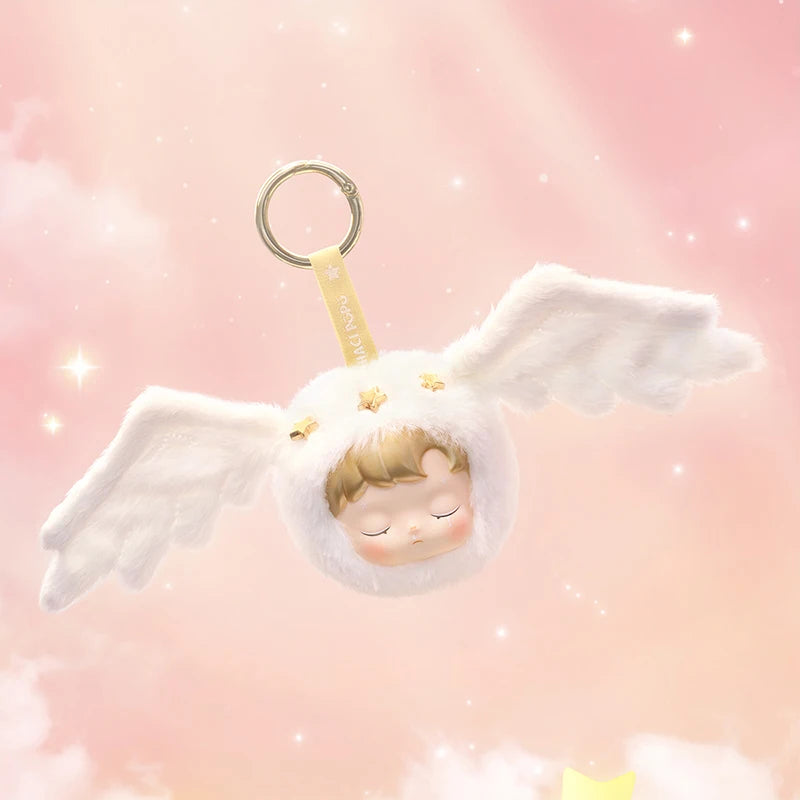 Plush angel keychain with wings on a pink background