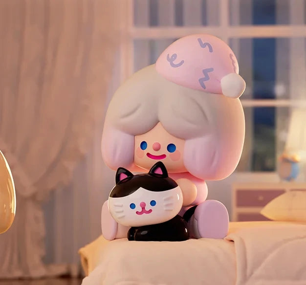 Cute character with pink hair and a black and white cat plush toy on a bed.