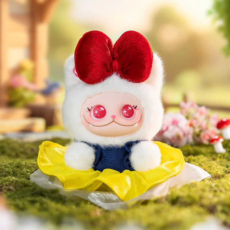 Plush toy with a red bow, white face, pink cheeks, and yellow dress sitting on grass.