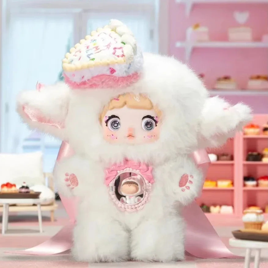 Plush toy with a character face and cupcake hat in a pink-themed room