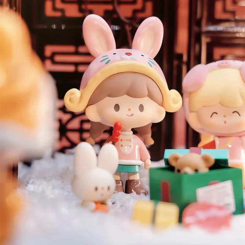 Toy figure of a girl with bunny ears and a small dog in a playful setting