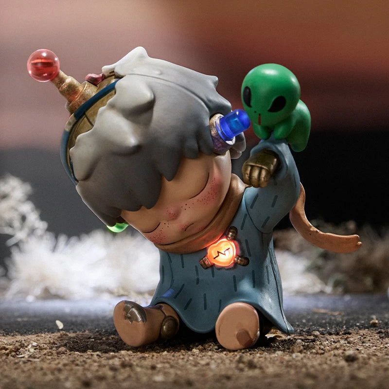 Toy figure of a character with a green alien on its back, standing on a textured surface.