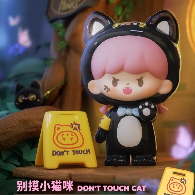 Toy figure of a character with cat ears and a 'Don't Touch' sign in a colorful setting