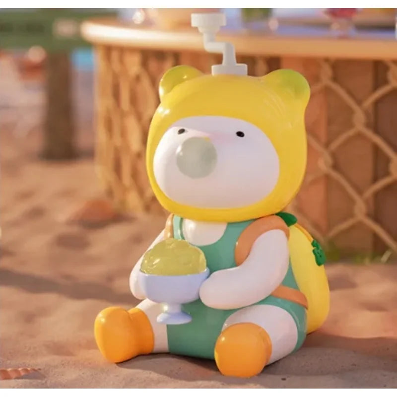 Colorful cartoon character toy with a yellow hat and ice cream, sitting on a sandy surface.
