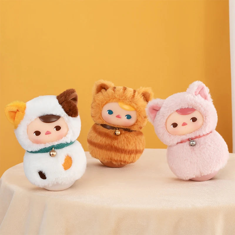 Three plush toys with animal-themed costumes on a beige surface against an orange background