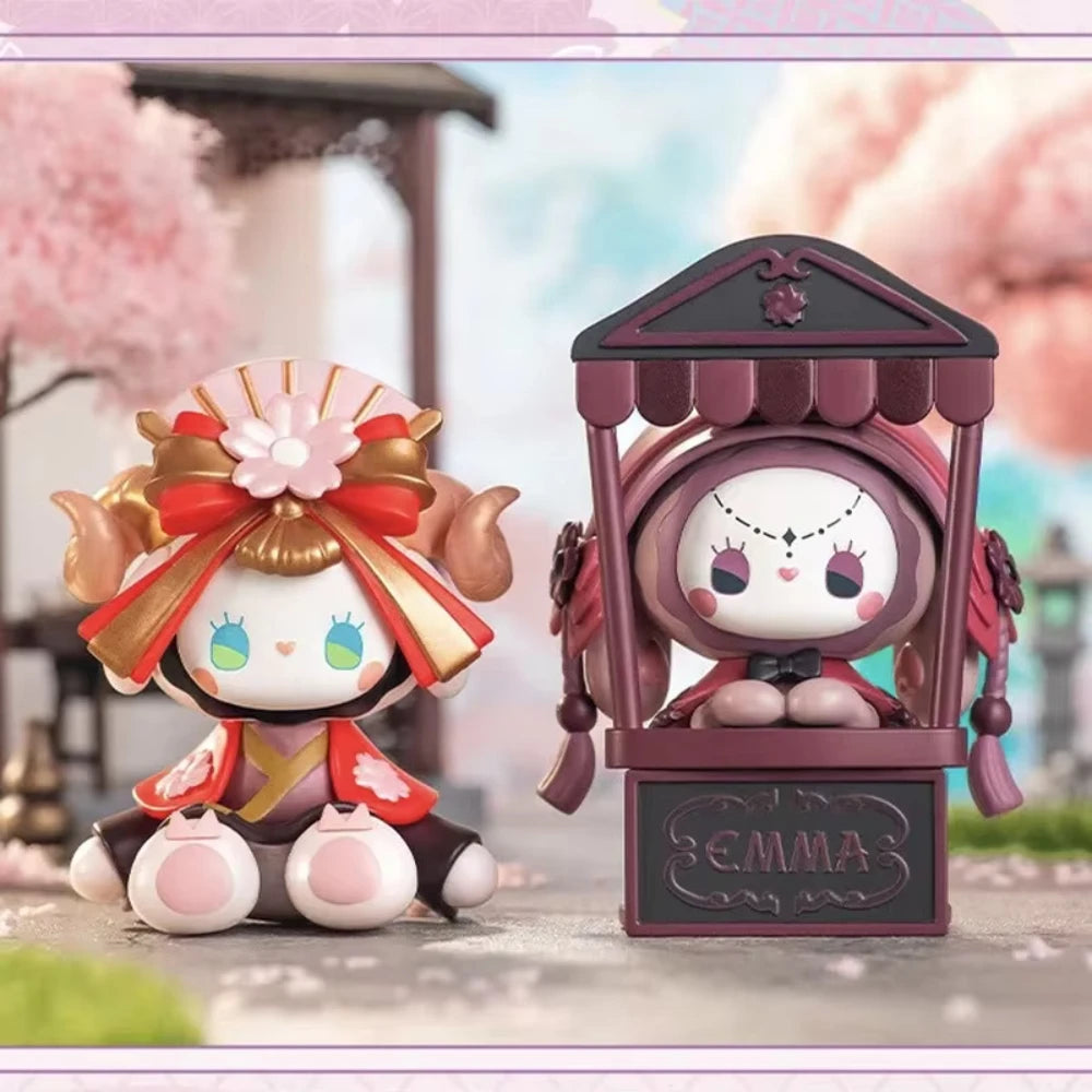 Two cartoon character figurines with cherry blossom background
