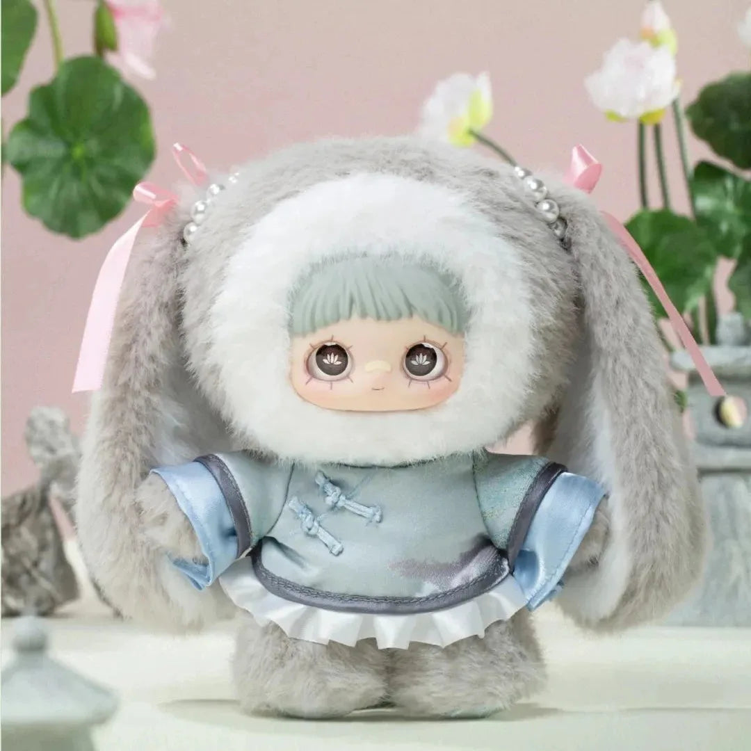 Plush toy with large ears and a light blue outfit in a decorative setting
