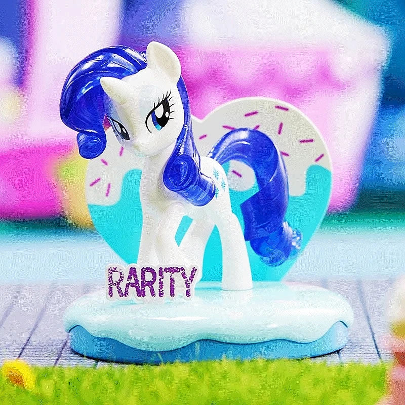 Toy figure of a pony with blue hair and 'Rarity' written on it, on a colorful background.