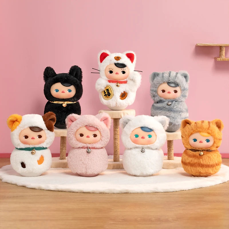 Set of small plush toys with animal-themed hats on a pink background