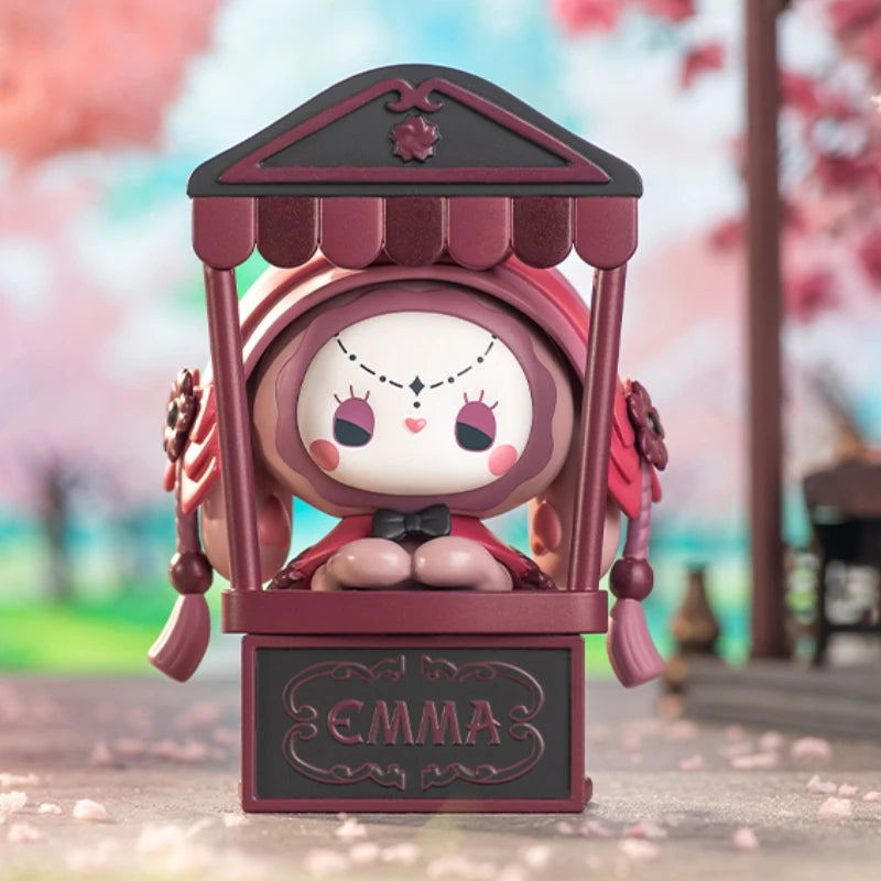 Animated character figure named 'Emma' in a decorative frame with cherry blossom background