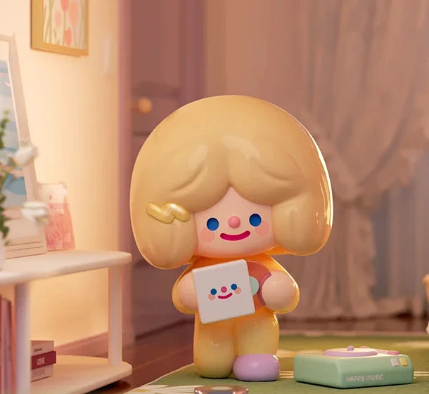 Toy figure with blonde hair holding a card in a room setting