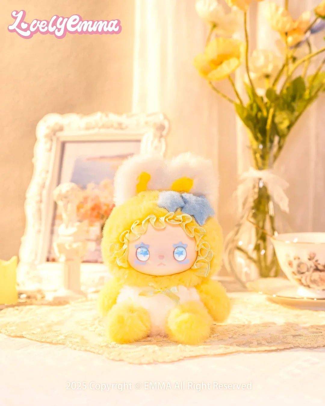 Yellow plush toy with blue bow on a decorative table with flowers and a photo frame.