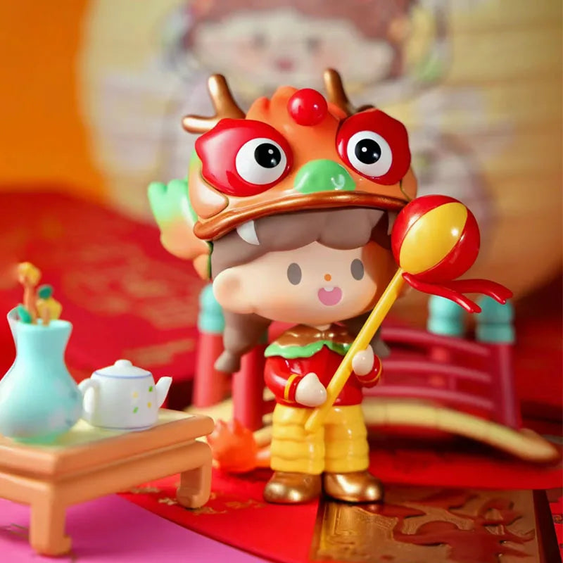 Colorful toy figure with a dragon costume holding a yellow spoon, set against a blurred festive background.