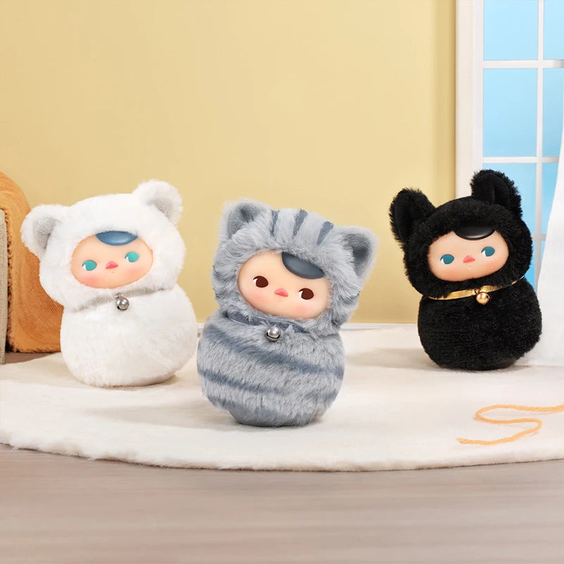Three plush toys in different costumes on a light-colored surface with a neutral background