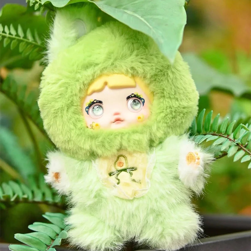 Plush toy in a green costume with a plant background