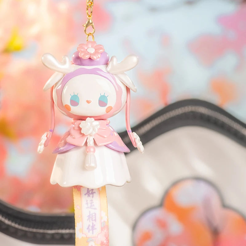Cute character keychain with a blurred floral background