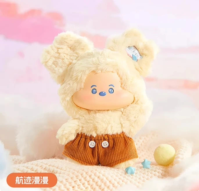 Plush toy with a bear-like design wearing a brown outfit on a soft, blurred background
