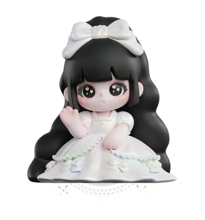 Figurine of a character with black hair and a white bow, wearing a white dress on a white background