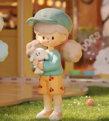 Decorative figurine of a child holding a teddy bear with a blurred background