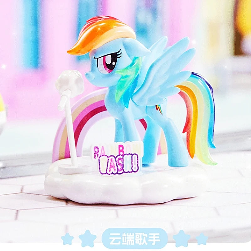 Colorful toy pony figure on a cake with 'Happy Birthday' candles