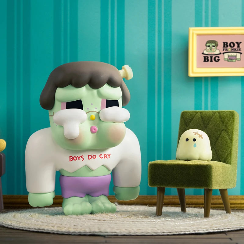 Cartoonish character with a sad expression sitting on a green chair against a teal striped wall.