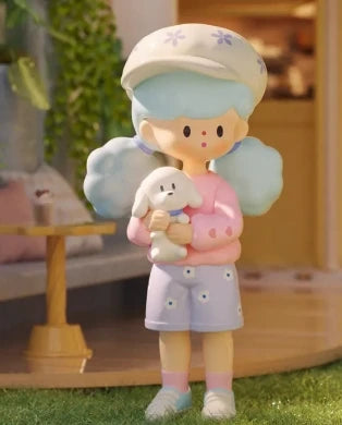 Toy figure of a child holding a lamb with a soft background