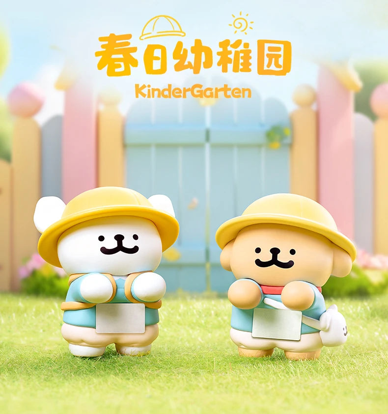 Two cartoon animal figurines in yellow hats on grass with 'KinderGarten' text in the background