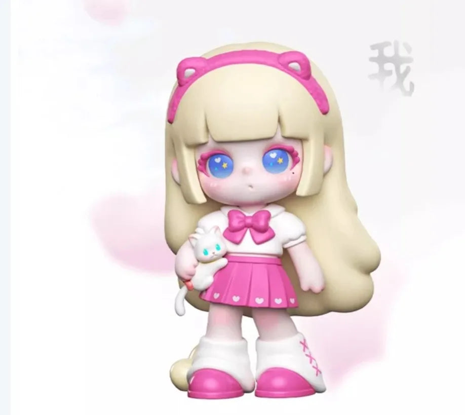 Toy figure with blonde hair, blue eyes, and a pink outfit holding a small white cat plush toy.