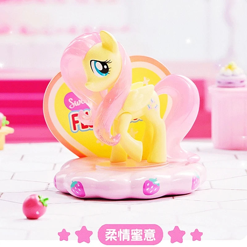 Toy figure of a yellow pony with pink hair on a pink stand with heart design.