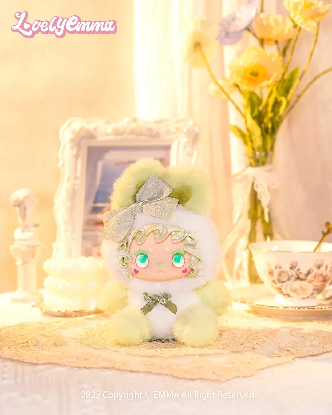 Plush toy with green hair and outfit on a decorative surface with 'Lovely Emma' branding.