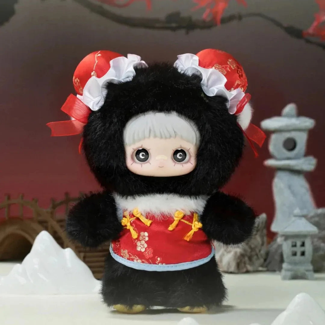 Plush toy with black fur and red outfit in a decorative setting